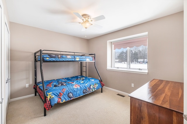 bedroom featuring ceiling fan and carpet