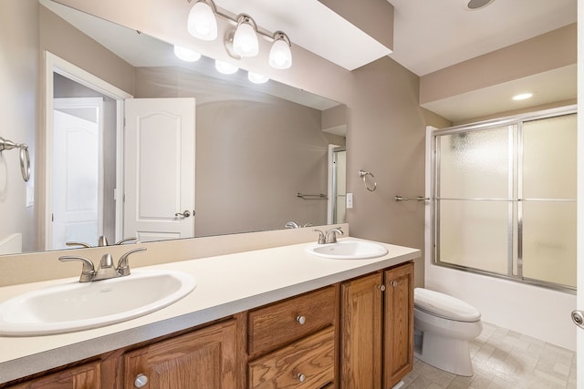 full bathroom with toilet, vanity, and shower / bath combination with glass door