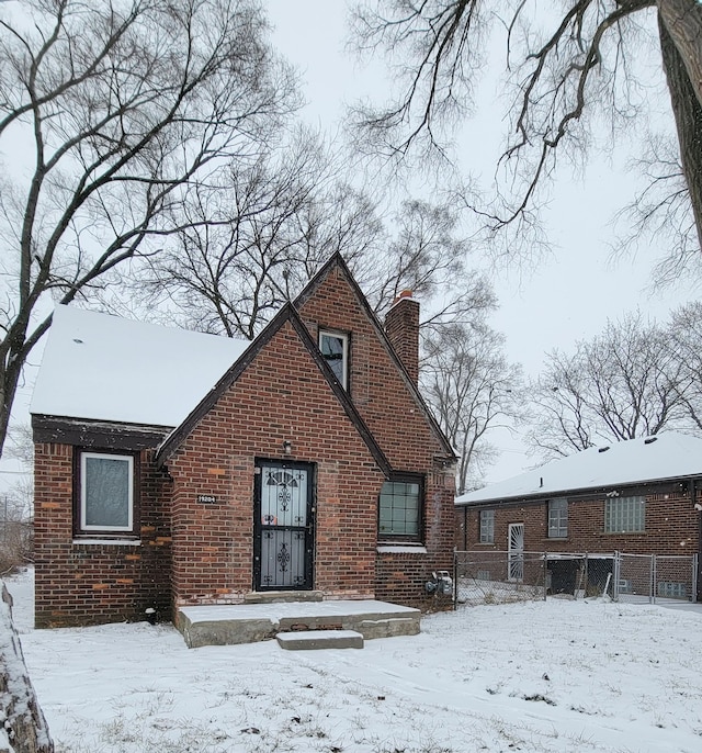 view of snow covered back of property