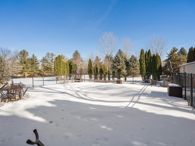 yard covered in snow featuring a patio area