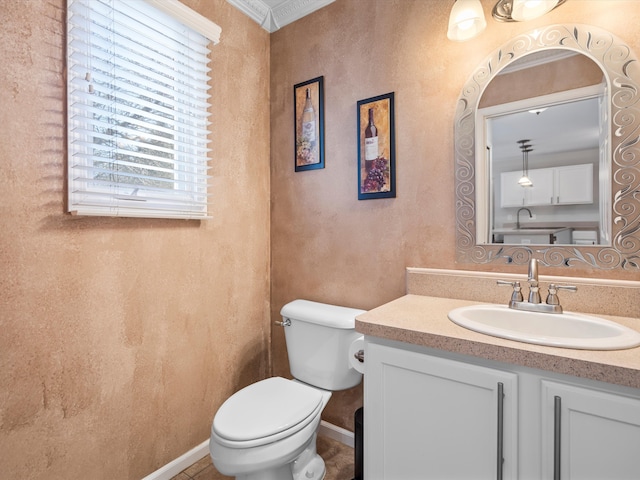 bathroom featuring crown molding, vanity, and toilet