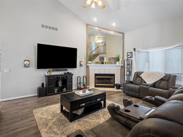 living room with hardwood / wood-style flooring, a fireplace, high vaulted ceiling, and ceiling fan