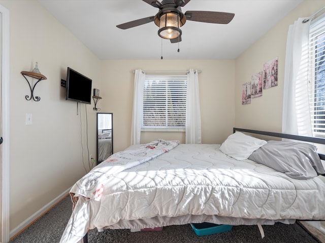 bedroom featuring multiple windows, carpet flooring, and ceiling fan