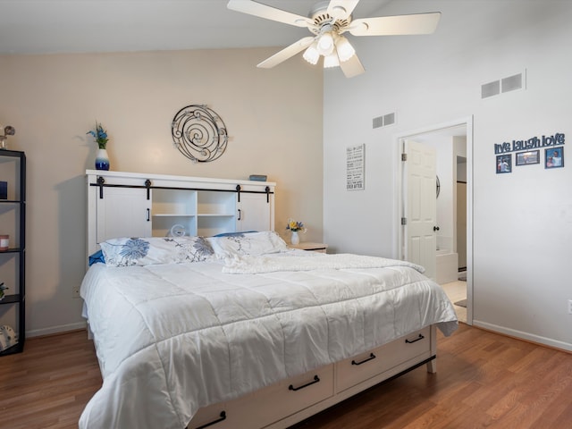 bedroom with lofted ceiling, wood-type flooring, and ceiling fan