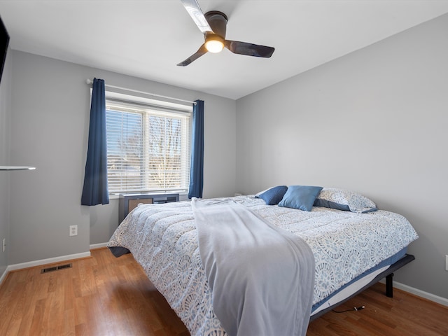 bedroom with hardwood / wood-style floors and ceiling fan