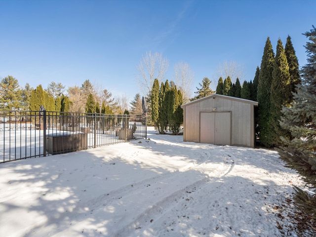 snowy yard with a storage unit