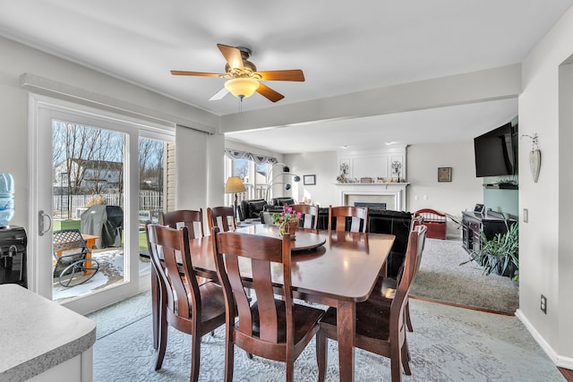 carpeted dining area featuring ceiling fan