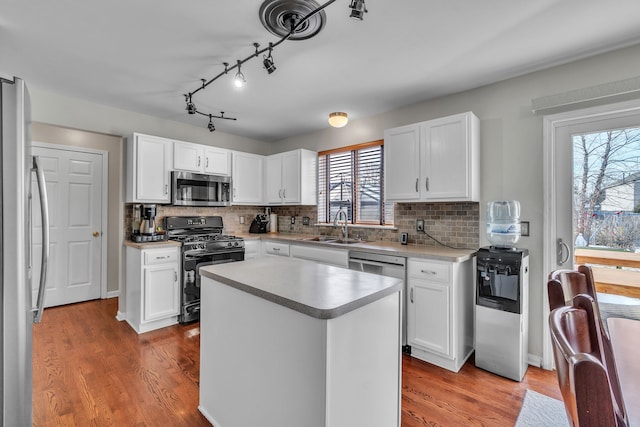 kitchen with white cabinetry, a kitchen island, and appliances with stainless steel finishes