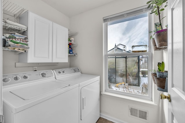 laundry room featuring cabinets and washing machine and dryer