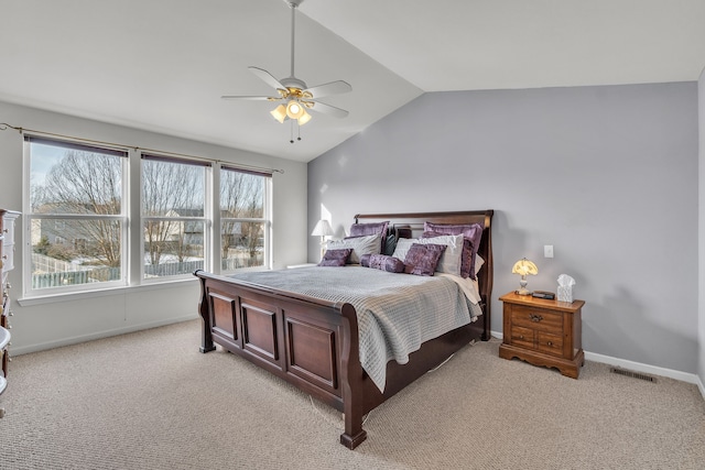 bedroom featuring vaulted ceiling, light colored carpet, and ceiling fan