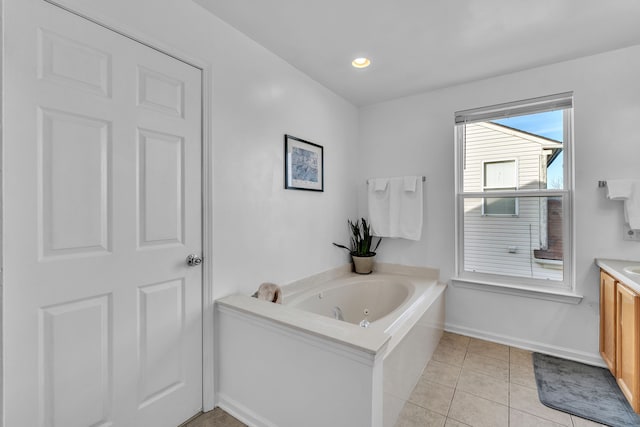 bathroom with tile patterned floors, vanity, and a tub