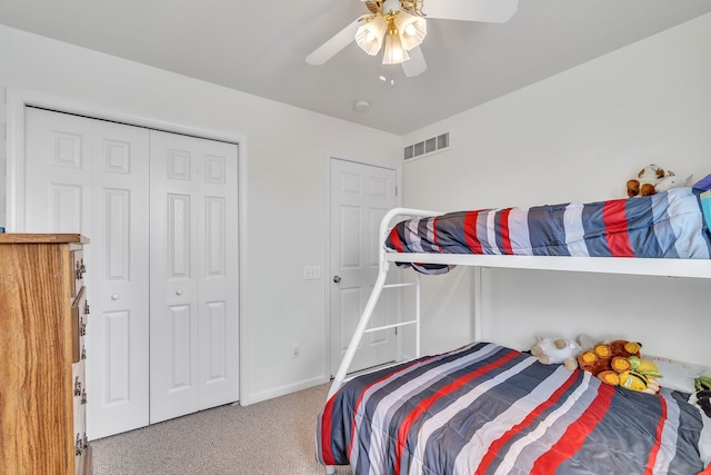 carpeted bedroom with a closet and ceiling fan