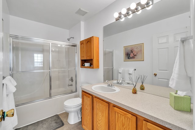 full bathroom with toilet, vanity, shower / bath combination with glass door, and tile patterned flooring