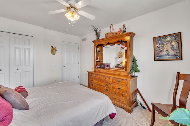 carpeted bedroom featuring a closet and ceiling fan