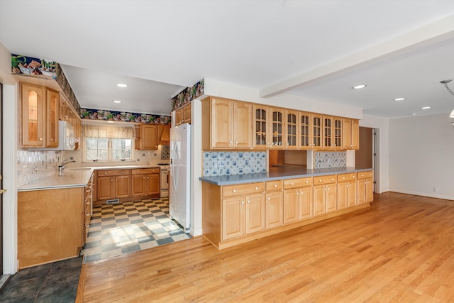 kitchen featuring tasteful backsplash, white appliances, sink, and light wood-type flooring