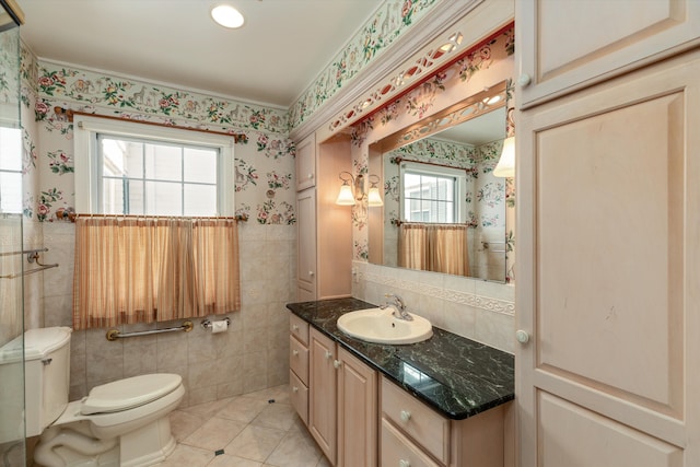 bathroom with tile walls, vanity, tile patterned flooring, and toilet