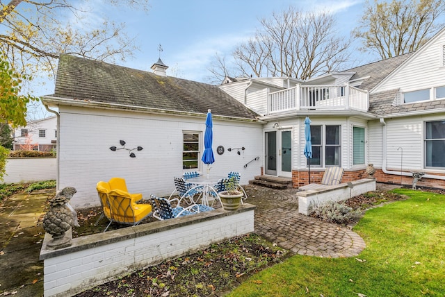 back of house with a balcony and a patio area