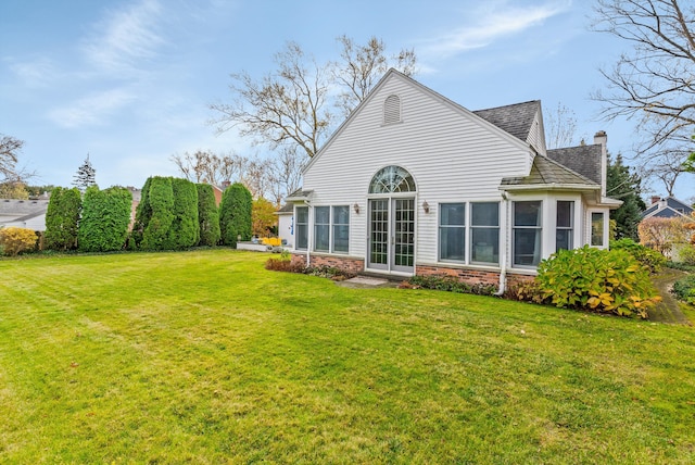 back of house featuring a yard