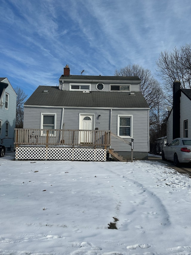 view of snow covered rear of property