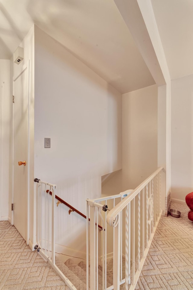 hallway featuring light colored carpet