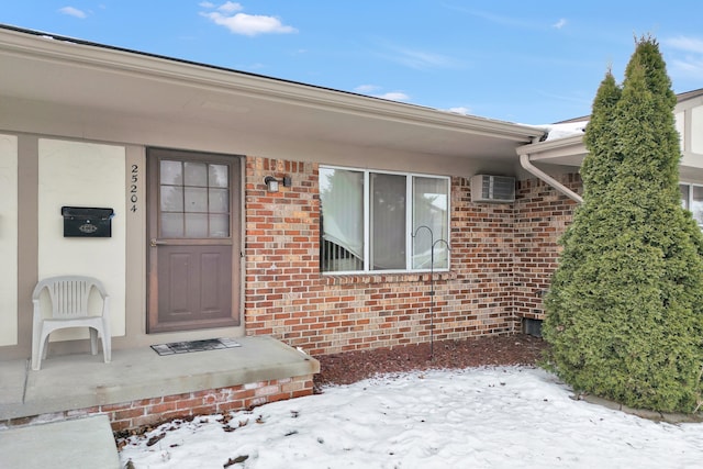 view of snow covered property entrance