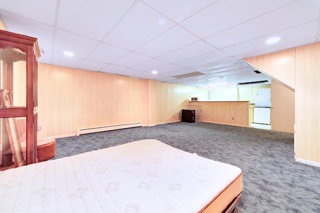 bedroom with carpet floors, a baseboard radiator, wooden walls, and a paneled ceiling