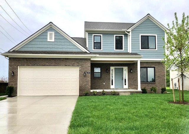 view of front of house featuring a garage and a front lawn