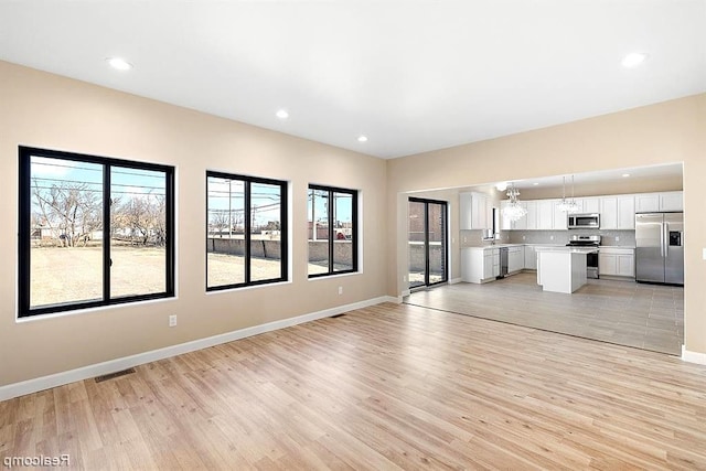 unfurnished living room with light hardwood / wood-style flooring