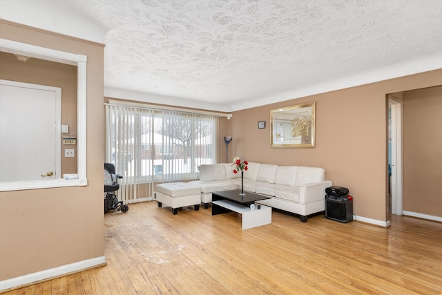 living room featuring a textured ceiling and light hardwood / wood-style flooring