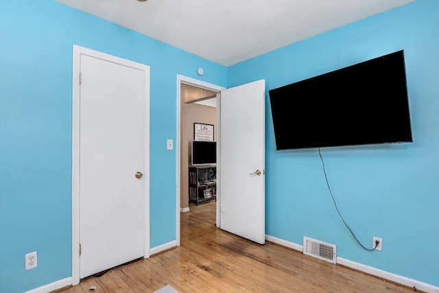 unfurnished bedroom featuring light wood-type flooring