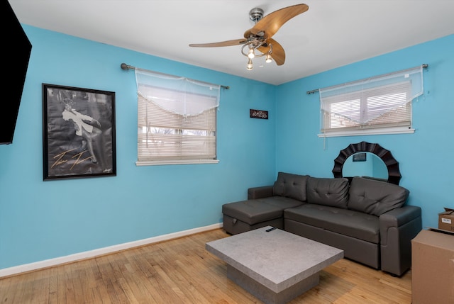 living room featuring ceiling fan and light wood-type flooring