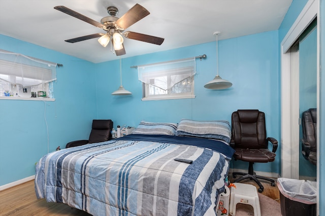 bedroom featuring hardwood / wood-style flooring and ceiling fan