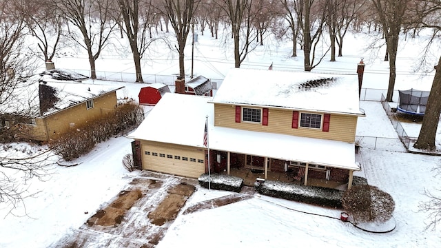 view of front facade with a garage and a trampoline