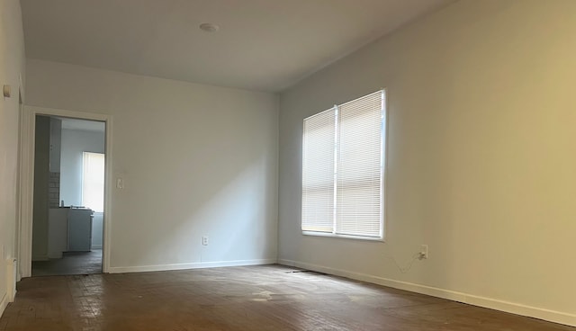 spare room with dark wood-type flooring