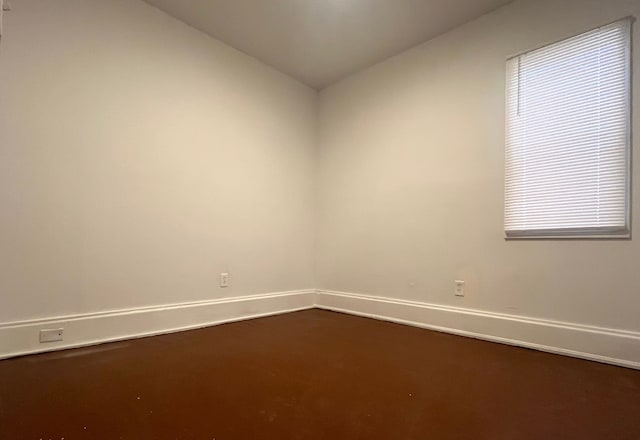 spare room with lofted ceiling