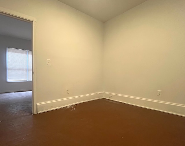 unfurnished room featuring dark hardwood / wood-style floors