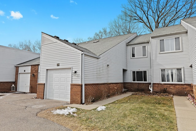 view of side of property featuring a garage and a yard