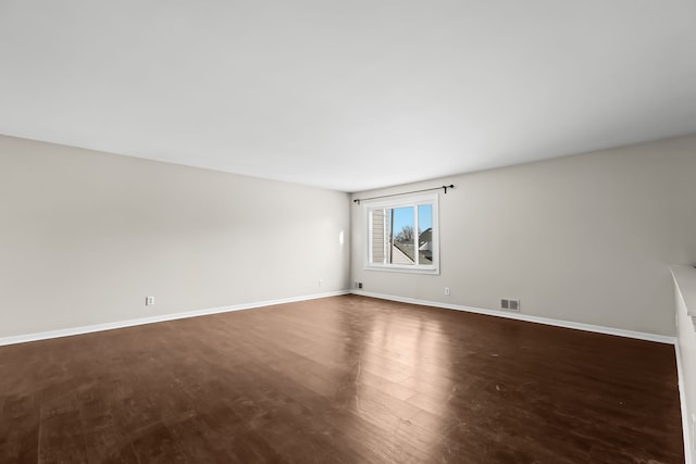 spare room with dark hardwood / wood-style floors