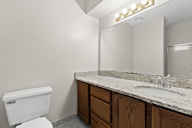 bathroom with vanity, tile patterned floors, and toilet