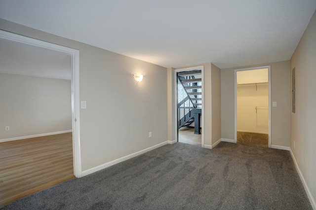 unfurnished bedroom with dark colored carpet