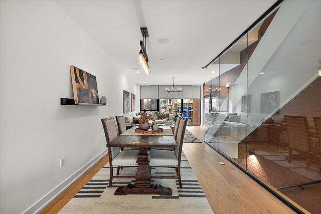 dining area featuring an inviting chandelier and hardwood / wood-style floors