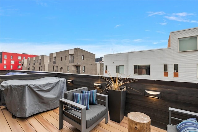 wooden terrace with a grill