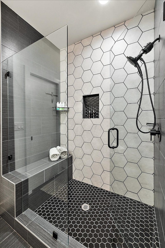 bathroom with a shower with shower door