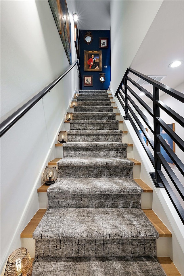 stairway with hardwood / wood-style flooring