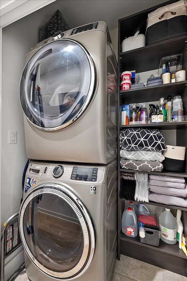 washroom featuring stacked washer / drying machine