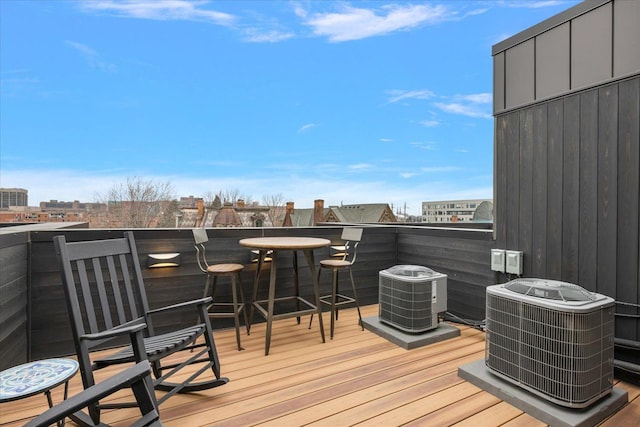 wooden terrace with central AC and an outdoor bar