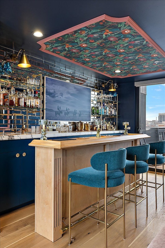 bar featuring light hardwood / wood-style floors