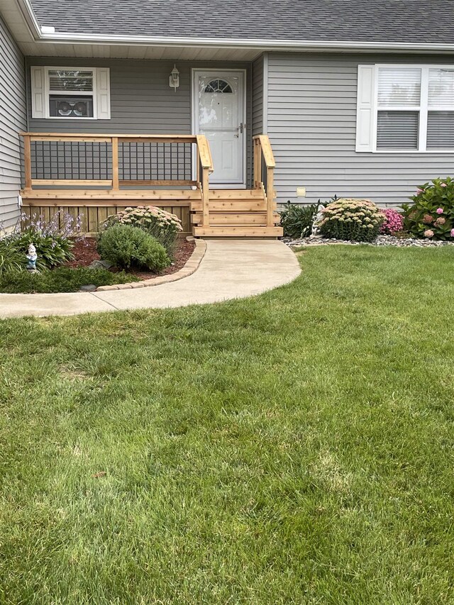 view of exterior entry with a lawn