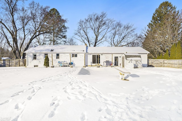 view of snow covered rear of property