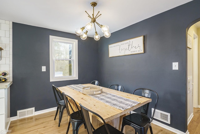 dining room featuring a notable chandelier and light hardwood / wood-style floors